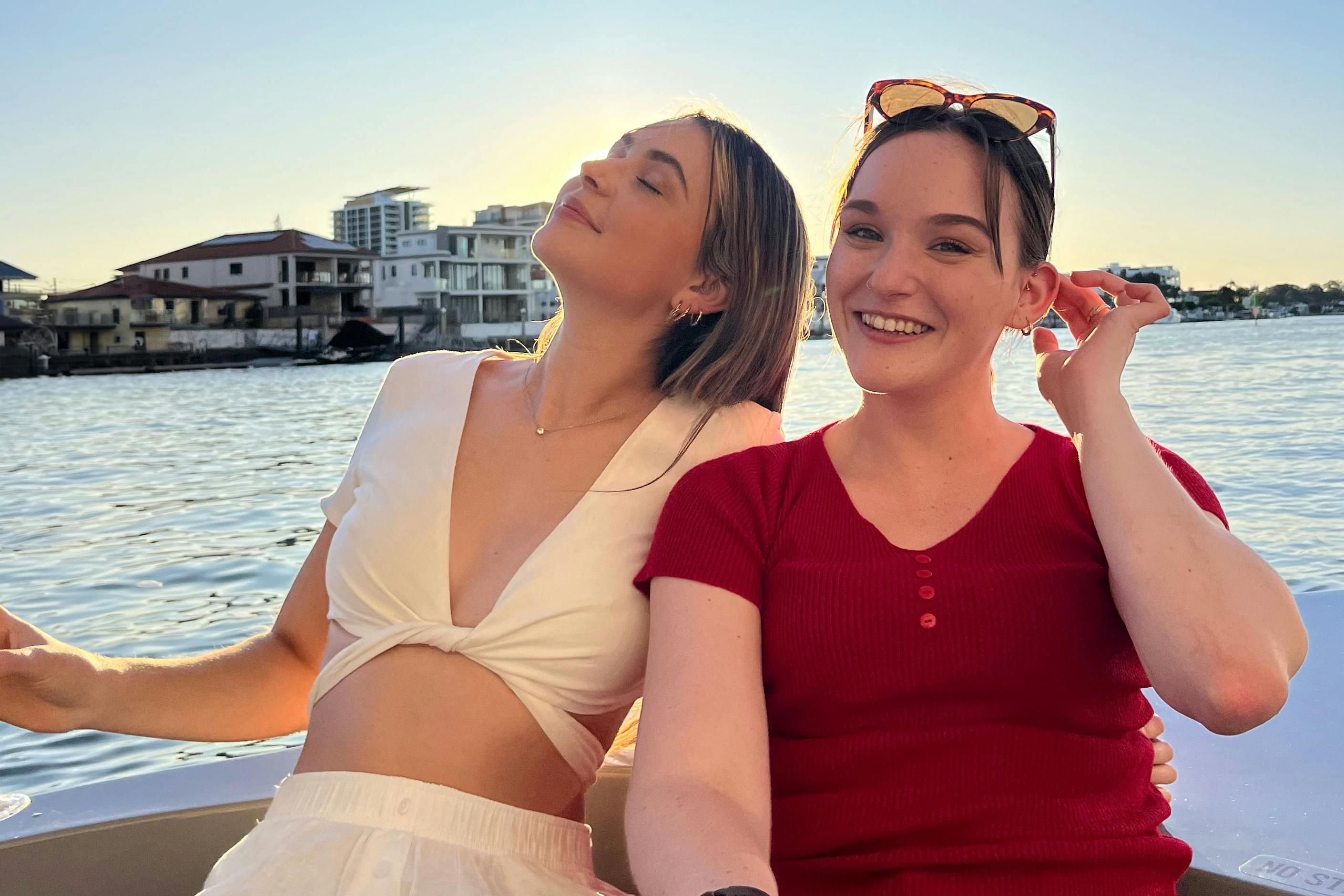 Two girls on a boat enjoying the summer sun